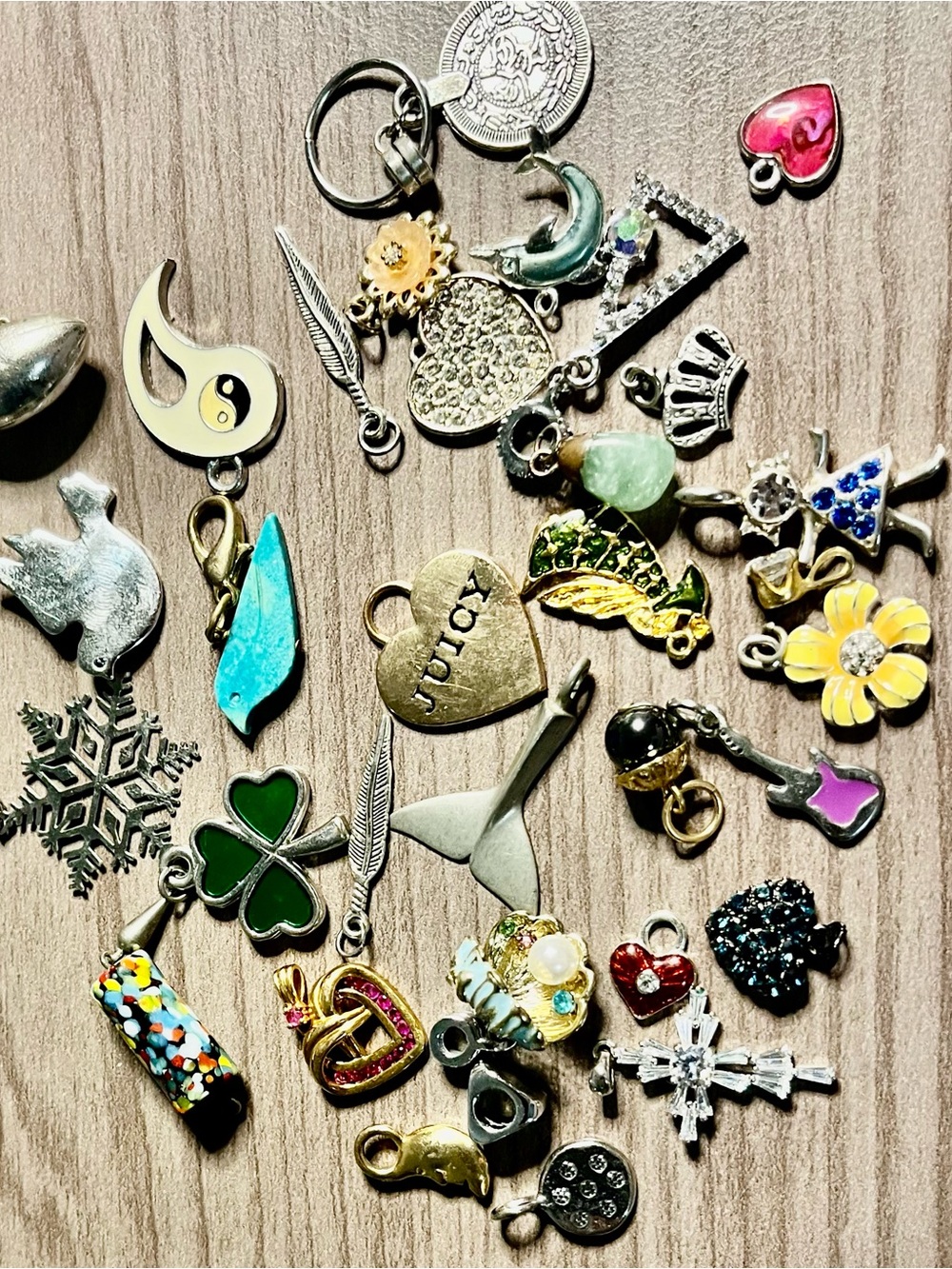 Small vintage pendants and trinkets all different sizes and colors.